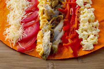 Ingredients for cooking shawarma lie on a pita bread. Middle Eastern dish to grill.