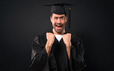 Man on his graduation day University annoyed angry in furious gesture. Frustrated by a bad...