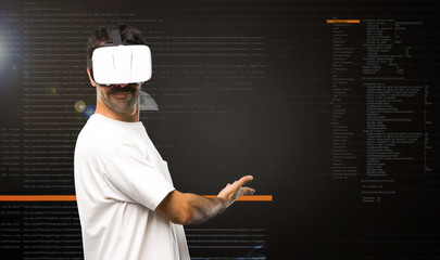 Naklejka premium Man using VR glasses pointing back inside the virtual reality mode