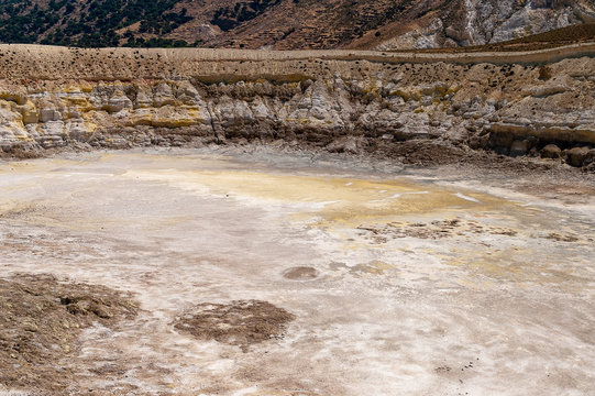 A vulcan crater with dangerous molten surfur at midday