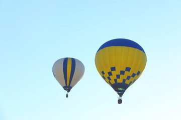 Colorful hot air balloons flying in blue sky