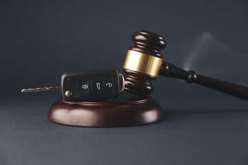 Car auction concept - gavel and car key on the wooden desk