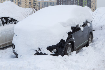 the cars on the parking under snow