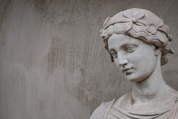 Ancient statue of sensual Greek renaissance era woman with a flower, Potsdam, Germany, details, closeup