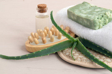 Natural handmade soap, washcloth and towel on wooden background.