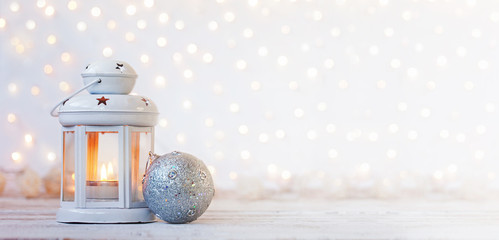 White lantern with candle and silver ball - Christmas decoration. Banner. © Volha Zaitsava