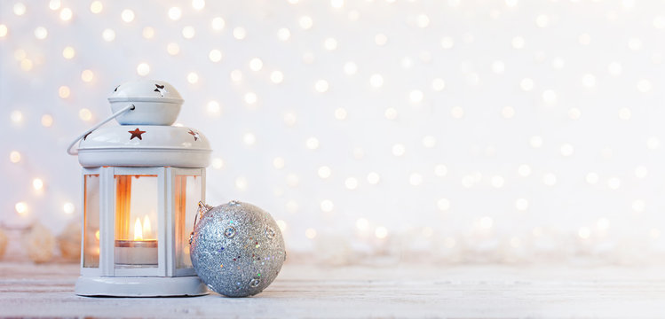 White lantern with candle and silver ball - Christmas decoration. Banner.