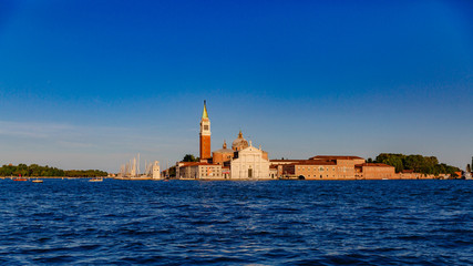 Fototapeta na wymiar San Giorgio Maggiore church and bell tower over water at sunset, in Venice, Italy