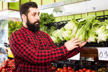 man seller showing salad