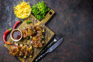 Smoked Roasted pork ribs over black background.