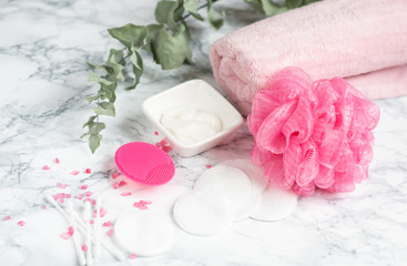 Obraz na płótnie Canvas Bathroom Accessories Silicone Face Massage Brush Towel White Cotton Wool Cosmetic Cream Gel SPA Concept Body Care Top View 
