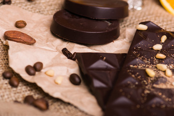 Dark chocolate, coffee, nuts, almonds close-up