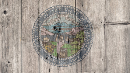 USA Politics News Concept: US State Nebraska Seal Wooden Fence Background