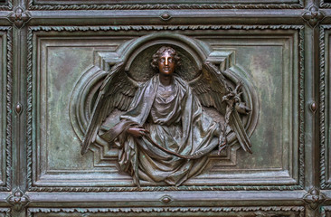 Detail of the Pieta scene in bas-relief at Milan's Cathedral doors