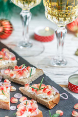 Mini sandwiches with feta cheese, pomegranates, red onions and rosemary. Holiday appetizers to wine for gourmets. New year. Christmas