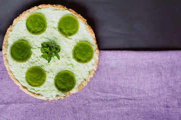 Freshly baked homemade  pie with jelly and mint on a dark background