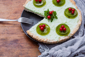 Freshly baked homemade berry pie with jelly on a wooden table