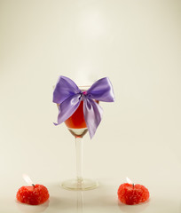 wine glass with ribbon and candles