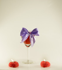 wine glass with ribbon and candles