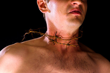 barbed wire, on the neck.  emotional portrait on a black background. neck in blood 