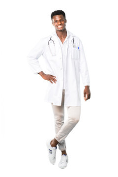 Full Body Of African American Doctor Posing With Arms At Hip And Smiling On White Background