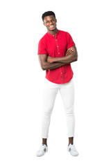 Fototapeta na wymiar Full body of Young african american man keeping the arms crossed while smiling on white background