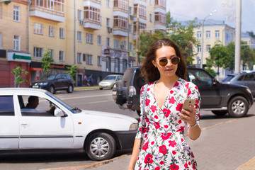 Girl with phone in city