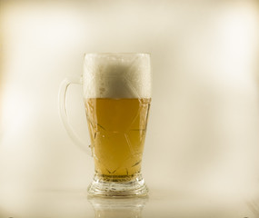 Filled with beer glass with white foam on a white isolated background