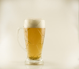 Filled with beer glass with white foam on a white isolated background