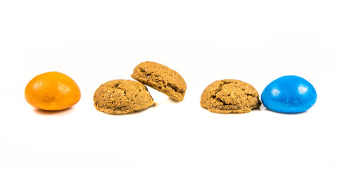 Row of colorful Pepernoten traditional dutch treats on white background