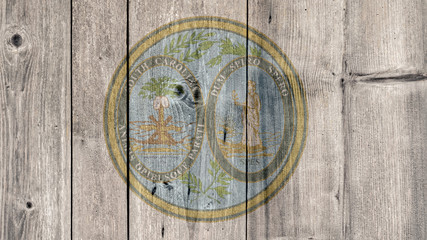 Fototapeta na wymiar USA Politics News Concept: US State South Carolina Seal Wooden Fence Background