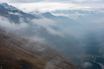 Mountain ranges partly engulfed in clouds