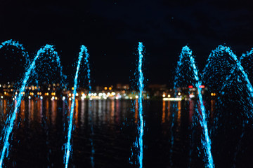 A stream of a fountain. Evening city.