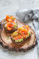 Danish open sandwich Smorrebrod with salmon on rye bread