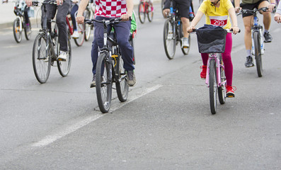 Naklejka na ściany i meble Bicyclists in traffic on the streets of the city