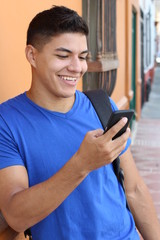 Young man laughing at cellphone