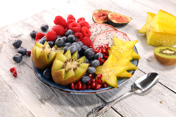 fruit bowl. Bowl of healthy fresh fruit salad on rustic background