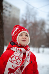 Winter portrait of kid boy in colorful clothes