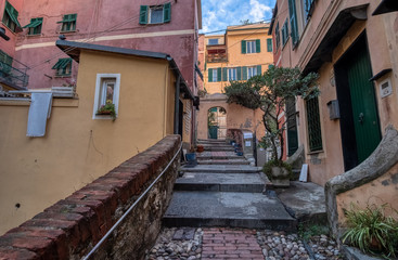 Fototapeta na wymiar Narrow street among the houses in the Boccadasse district in Genova, Italy