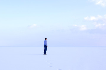 deadpan man standing shore frozen sea downshifting way relaxes winter seascape