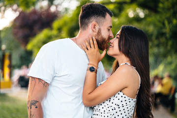 Handsome guy and beautiful girls kissing in the park