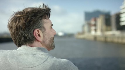 men is looking over a river and is thinking about his future