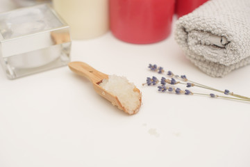 Spa care - candles, cream, towel. Flat lay, spa concept. 