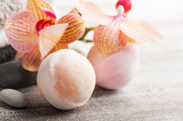 Spa still life with bath bombs and red orange orchid