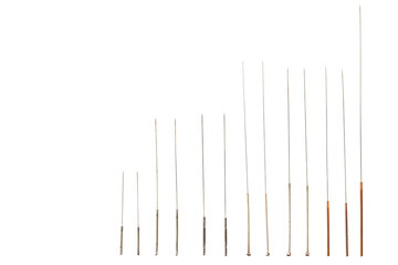 Silver needle acupuncture on an isolated white background. Close-up.