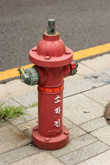 Red fire hydrant on a street in South Korea