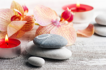 Fototapeta na wymiar Spa still life with pebbles and red orange orchid