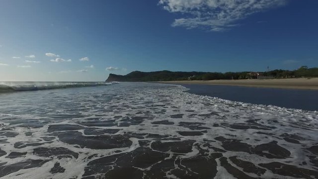 Playa Colorado beach in Nicaragua with mountains behind