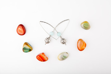 silver earrings blue agate stones white background 