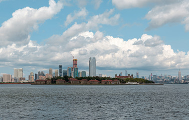 New York City / USA - AUG 22 2018: Ellis Island and midtown Manhattan skyscrapers view from the...